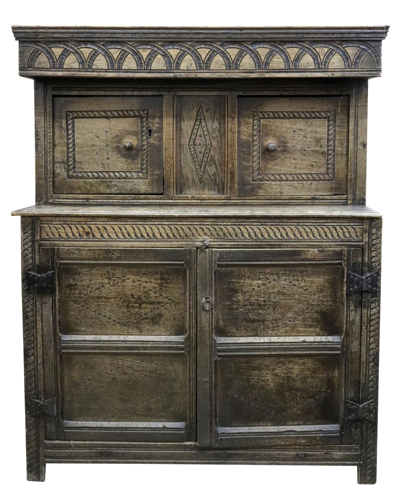 A Jacobean carved oak court cupboard, of