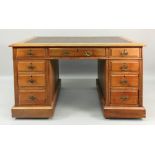 An Edwardian walnut kneehole desk, the i