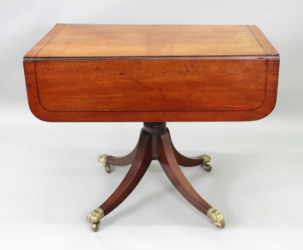 A Regency mahogany ebony strung breakfast table, with hinged drop leaves, end drawer,