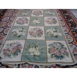 A Portuguese chain stitch needlework carpet with three x four panels in alternating green and ivory,