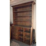 A 20th century pine kitchen dresser with three tier plate rack over five drawers,