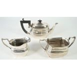 Silver tea wares, comprising; a teapot having black fittings, Birmingham 1922,