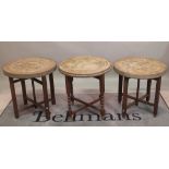 A set of three oak and brass folding circular occasional tables, 60cm diameter x 58cm high, (3).