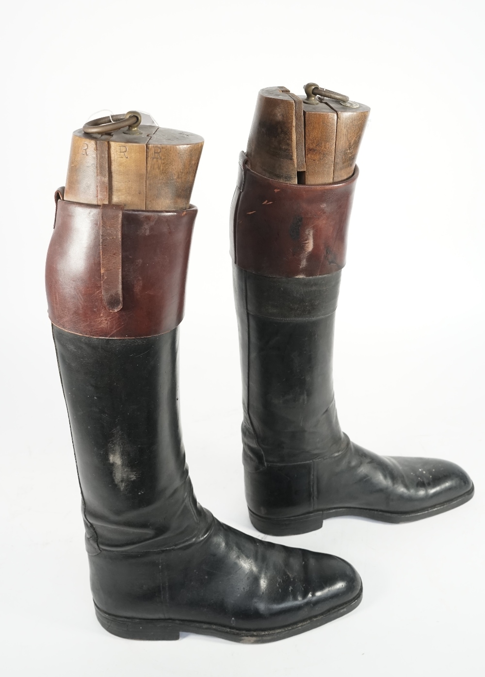A pair of gentleman's two tone leather riding boots with wood and brass mounted lasts,