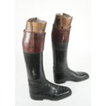 A pair of gentleman's two tone leather riding boots with wood and brass mounted lasts,