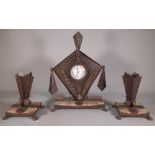 An Art Nouveau composite metal and onyx mantel clock with garnitures, 29cm wide x 45cm high.