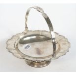 A silver cake or fruit basket, of shaped circular form, having a decorated rim,
