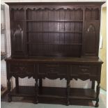 An 18th century style oak dresser with three tier plate rack,