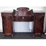 A Regency mahogany pedestal sideboard with central bow drawer,