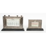A silver mounted ebonised wooden cased adjustable desk calendar,