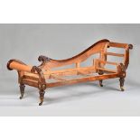 A Regency gilt metal mounted rosewood double scroll end chaise lounge frame, on carved supports,