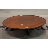 A 19th century and later mahogany lazy Susan with circular dished top on pad feet,