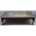A black and gilt Japanned low table, the top inset with 19th century Chinese panel,
