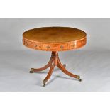 A George III inlaid mahogany drum table, with four true and four dummy drawers,