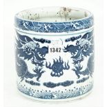 A modern Chinese style blue and white porcelain brush pot decorated with a dragon chasing a flaming