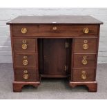 An 18th century mahogany kneehole writing desk, with seven drawers about the cupboard,