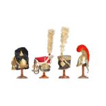 Four miniature model military helmets/hats comprising;