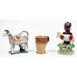 A Staffordshire pottery cow creamer, circa 1800, its coat sponged in brown, black and ochre,