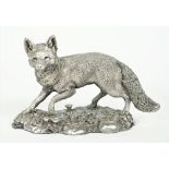 A silver model of a standing fox, raised on a shaped oval rustic base (detailed filled),