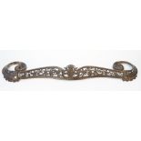 A patinated steel fire kerb, late 19th century, with a pierced foliate cast frieze and scroll ends,
