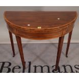 A George III mahogany satinwood banded demi-lune foldover card table on fluted tapering square
