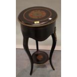 A late Victorian ebonised and ormolu mounted circular lift top side table on cabriole supports,