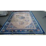 A Chinese carpet, the mushroom coloured field with a larger central leaf roundel,