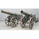 A pair of reproduction cast iron cannons, each on a pierced frame and spoked wheels, barrel, 100cm,