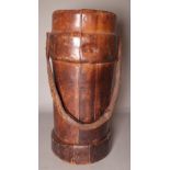 An early 20th century brown leather shot carrier, 41cm high.