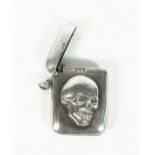 A silver vesta case, the front with an applied skull motif otherwise plain, by Smith & Bartlam,