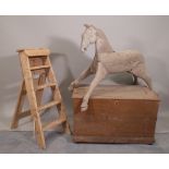 An early 20th century grey painted rocking horse, 96cm wide x 47cm high, a pine step ladder,