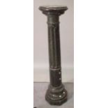 A verde marble pedestal with fluted central column, 108cm high.