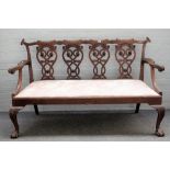 A 19th Chippendale revival carved mahogany quadruple chair back open arm sofa,