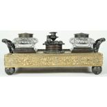 A George IV repousse brass and patinated inkstand, circa 1820, with twin handles,