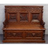 A 19th century carved oak box seat settle,