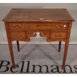 A George III oak low boy with three frieze drawers on tapering square supports,