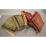 A group of four cushions, comprising; two red and gold and two green and gold,