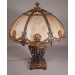A Tiffany style composite metal lamp of urn form, and matching glass shades.