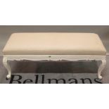 A Victorian style white painted rectangular footstool on cabriole supports, 120cm wide x 46cm high.