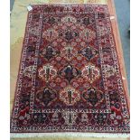 A Bidjar rug, Persian, the madder field with cartouches of trees and flowers,
