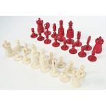A late 19th century stained bone chess set of turned form, king 9.5cm high.
