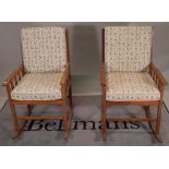 A pair of mid-20th century teak rocking armchairs, 58cm wide x 96cm high, (2).