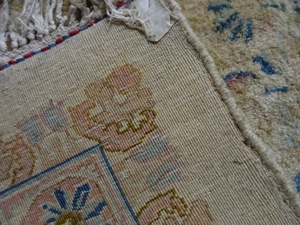 A Kerman carpet, Persian, the plain ivory field with an elongated floral medallion, - Image 9 of 11