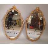 A pair of Victorian style gilt metal oval wall mirrors, 39cm wide x 66cm high, (2).