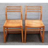 A set of four 20th century beech framed dining chairs, on canted block supports,