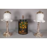 A pair of early 20th century silver plated table lamps with white glass shades,