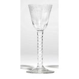 An opaque twist wine glass, circa 1765, the rounded funnel bowl engraved with fruiting vine,