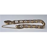 A gold curved bar link gate bracelet, on a gold heart shaped padlock clasp, detailed 15 CT,