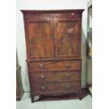 A George III mahogany linen press with walnut moulded panelled doors over three long graduated