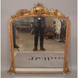 A Victorian gilt framed overmantel wall mirror with oak leaf carved surrmount,